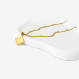 So Verily, With Hardship Comes Ease” Mini Diamond Calligraphy Necklace – 18K Gold Plated
