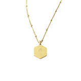 Back view of gold Al-Qadīr Necklace with smooth hexagon pendant and engraved Salaam Gallery logo, photographed on a clean white background.