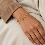 Amira Heart Charm Bracelet – 18K gold plated stainless steel, styled lifestyle shot