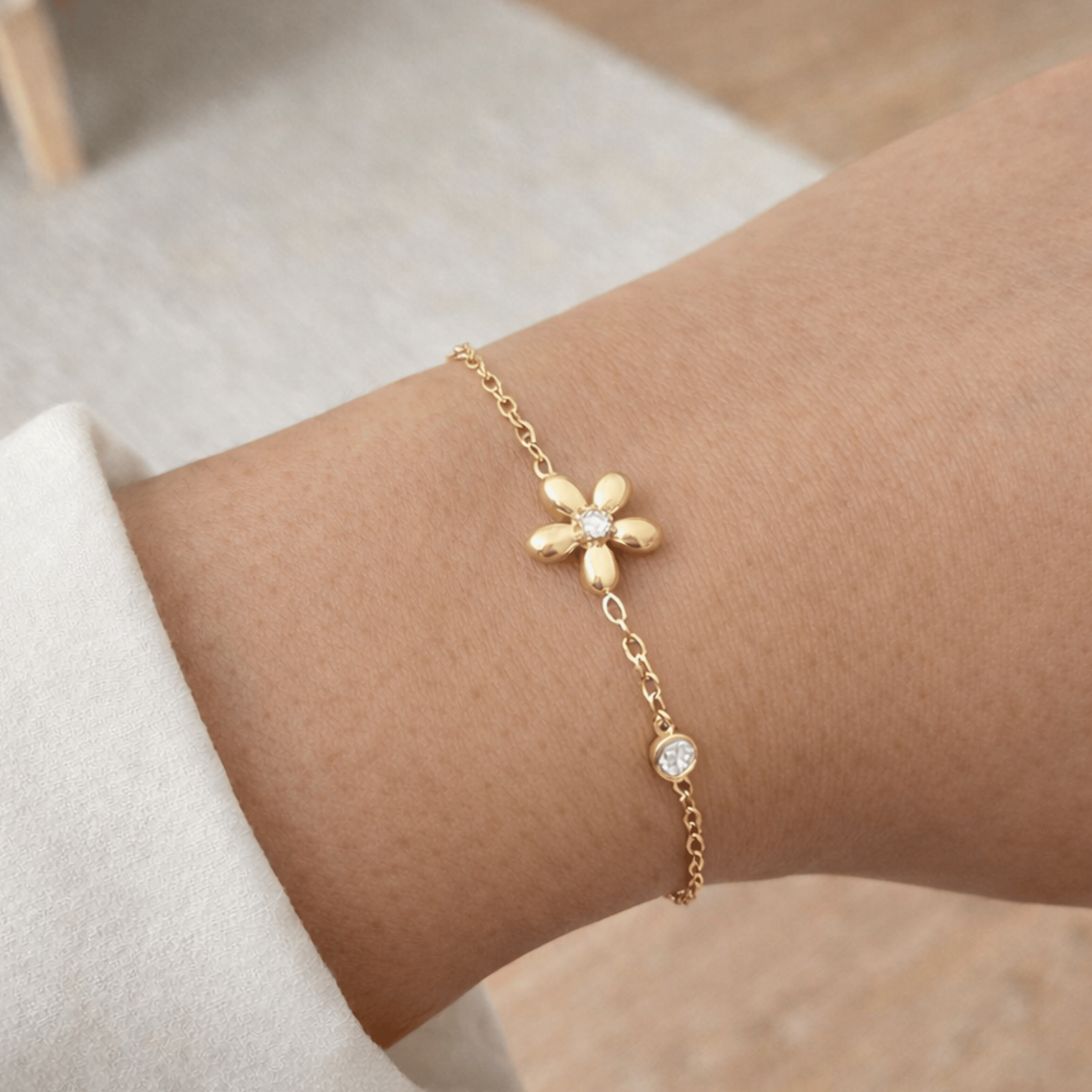 Bloom flower gold bracelet worn on wrist with crystal accents