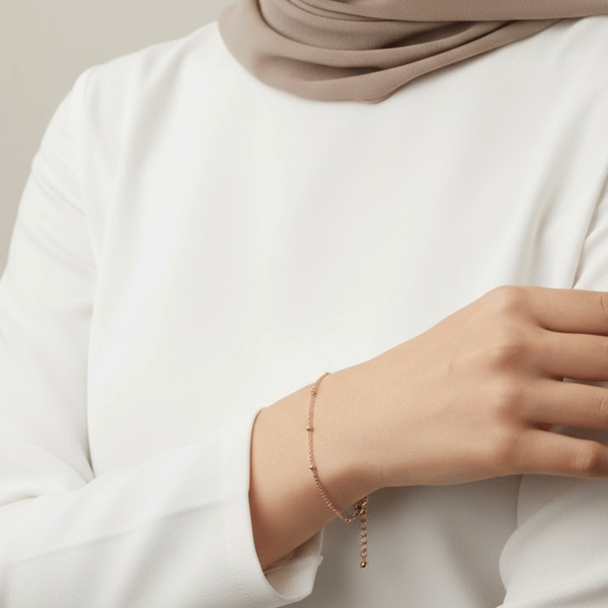 Dainty Dotted Bracelet in 18K gold plated stainless steel styled on wrist with modest neutral outfit