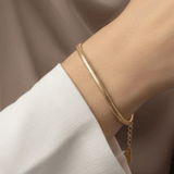 Dainty Snake Bracelet worn on wrist featuring sleek rounded 18K gold plated stainless steel snake chain