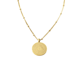 Guide Us to the Straight Path Necklace in gold featuring Arabic Quran verse “Ihdināṣ-ṣirāṭal-mustaqīm” engraved on a circular pendant, displayed on a white background.