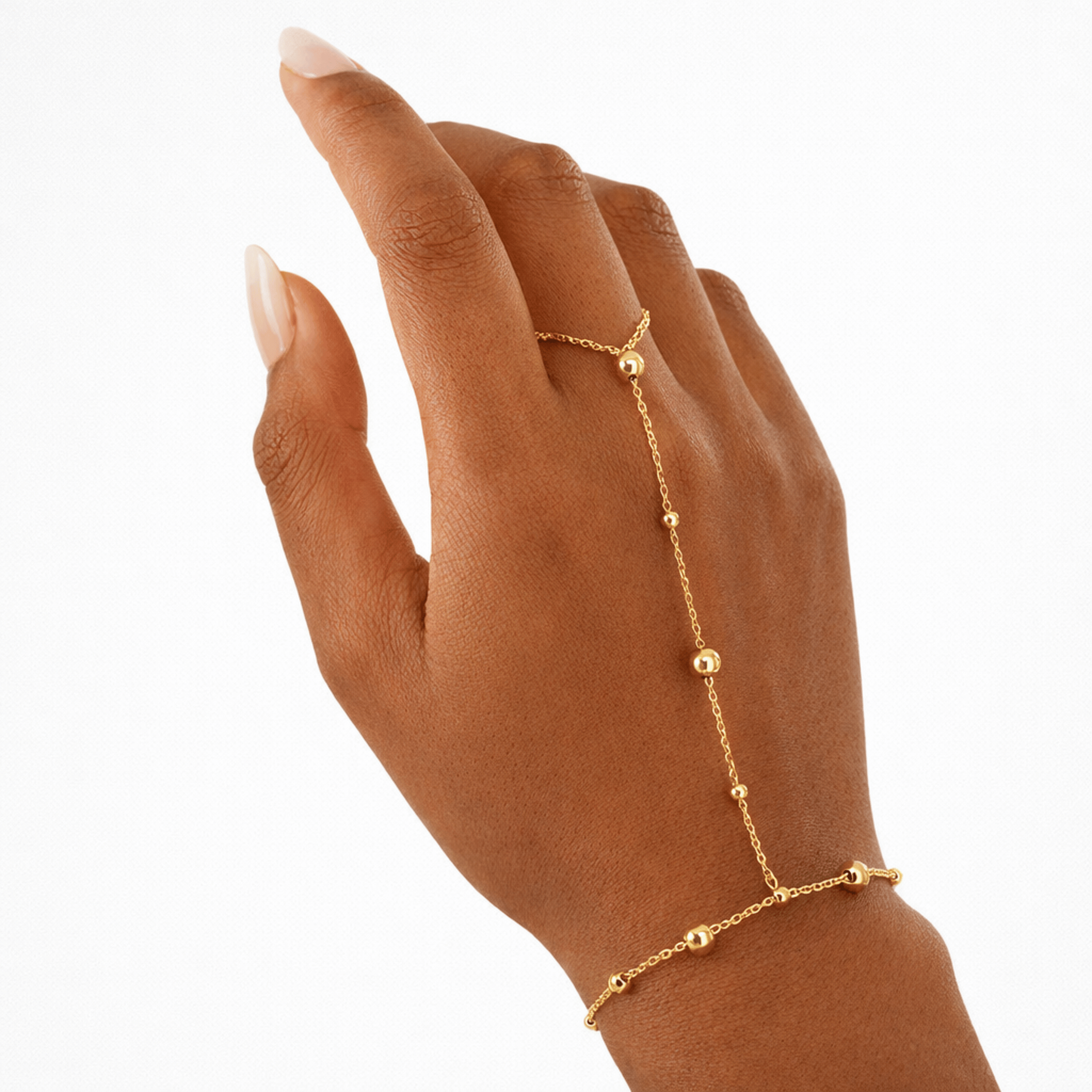 Halo Dotted Hand Chain worn on hand in 18K gold plated stainless steel with dotted bead detailing and finger loop connection.