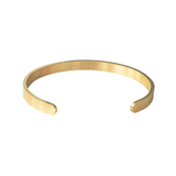 Inside view of gold Hidden Reminder Cuff showing Salaam Gallery engraving and open cuff construction.