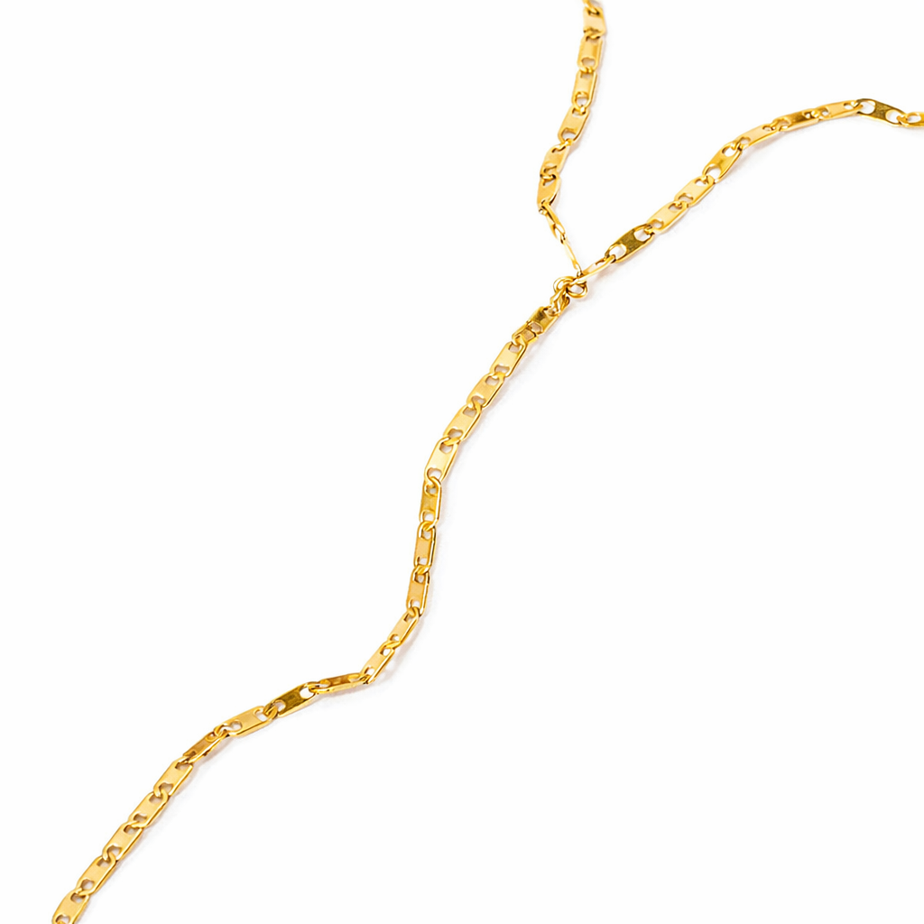 Close-up of Infinity Link Hand Chain showing interconnected gold link pattern and polished finish