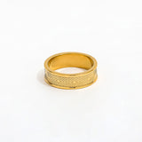 Gold ring with geometric pattern on a white background