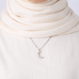 Qamar Crescent Pendant gold crescent moon necklace styled with neutral outfit