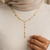 Qatra Drop Lariat Necklace – 18K gold plated stainless steel, styled lifestyle shot