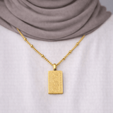 Gold Remember Me Necklace worn by a modest woman, featuring Quran verse from Surah Al-Baqarah Ayah 152, styled with a white top and neutral hijab.