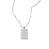 Back view of silver Remember Me Necklace with minimalist rectangular pillar pendant and engraved logo, displayed on a clean white background.