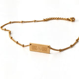 Tawakkul Bar Necklace with توكل Arabic calligraphy and Islamic geometric pattern – 18K Gold Plated, close-up