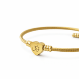 Close up of Tawakkul Love Bangle heart charm engraved with Arabic calligraphy توكل