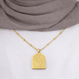 Gold Ud‘ooni Necklace worn by a modest woman, featuring Quran verse “Call Upon Me, I Will Respond,” shown styled over a white top and neutral hijab.