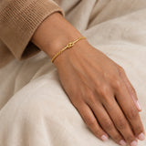 Wafa Knot Bracelet – 18K gold plated stainless steel, styled lifestyle shot